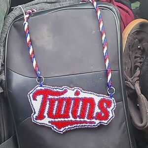 A hand beaded Minnesota Twins emblem and chain